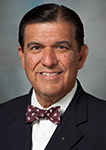Senator Eddie Lucio Jr. smiling wearing a bowtie