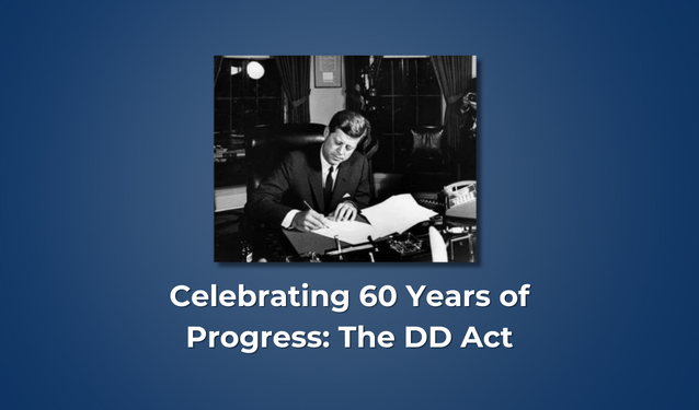 Photo of President John F. Kennedy signing the DD Act