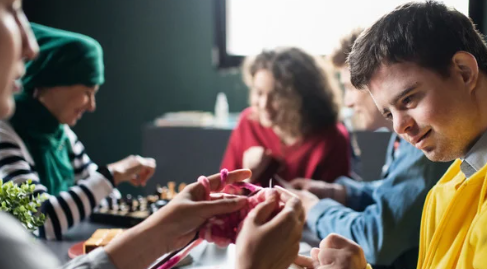 A group of adults learn how to craft together
